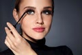 Woman With Beauty Makeup, Long Black Eyelashes Applying Mascara Royalty Free Stock Photo