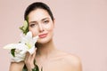 Woman Beauty Natural Makeup Portrait with Lily Flower, Happy Girl Face Skin Care and Treatment Royalty Free Stock Photo