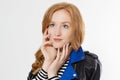 Woman beauty power. Close up of red haired girl face and leather jacket isolated on white background. Skin care, blue eyes Royalty Free Stock Photo