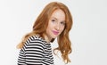 Woman beauty power. Close up of red haired girl face, leather jacket on white background. Skin care, blue eyes