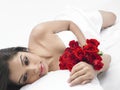 Woman in bed with a bouquet Royalty Free Stock Photo