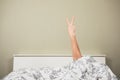 Woman in bed displaying obscene gesture Royalty Free Stock Photo