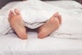 Woman on the bed at home with their feet showing Royalty Free Stock Photo