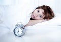 Woman in bed with insomnia that can't sleep with alarm clock Royalty Free Stock Photo