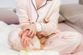 Woman on bed in pajama scratching her itchy hand.Healthcare and medical concept Royalty Free Stock Photo