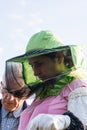 Woman beekeeper looks after bees in the hive