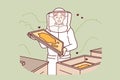 Woman beekeeper stands in apiary among hives and flying bees, takes out honeycombs with honey