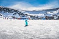 Woman, beginner snowboarder learning how to ride on a snowboard, Andorra