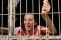 Woman behind bars crying Royalty Free Stock Photo