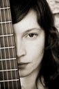 Woman behind guitar fretboard