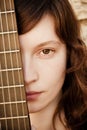 Woman behind guitar fretboard Royalty Free Stock Photo