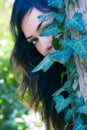 Woman behind leaves