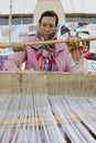 Woman behind an old spinning machine