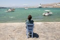 Woman from behind sitting in a chair watches Royalty Free Stock Photo