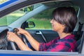 Woman behind steering wheel in car Royalty Free Stock Photo