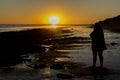 Woman watching the sunset on a beach Royalty Free Stock Photo