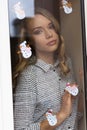 Woman behind window in winter time Royalty Free Stock Photo