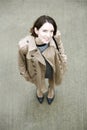 Woman at beige coat and gray square concrete