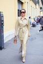 Woman with beige leather trench coat walking before Boss fashion show, Milan Fashion Week