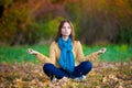 Woman in beige sweater, blue jeans and scarf meditation
