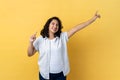 Woman being in good festive mood, dancing, raising hands, expressing happiness.