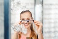 Woman being satisfied with the new eyeglasses she bought in the store Royalty Free Stock Photo