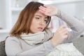 woman being sick having flu lying on sofa Royalty Free Stock Photo