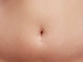 Woman belly with piercing scar in the navel Royalty Free Stock Photo