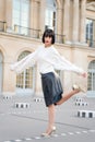 Woman bend leg on square in paris, france Royalty Free Stock Photo