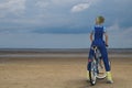 Woman with bicycle on beach Wadden North Sea