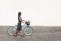 Woman with a bicycle in a city