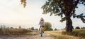 Woman on a bicycle having fun in rural landscape