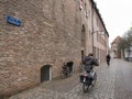 Woman on bicycle in old city of zwolle near ancient town wall