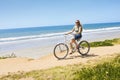 Woman on a Bicycle Ride along the beach Royalty Free Stock Photo