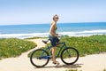 Woman on a Bicycle Ride along the beach Royalty Free Stock Photo