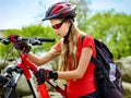 Woman on bicycle ride mountain. Girl traveling in summer park.