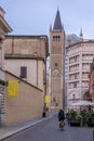 A woman on a bicycle rides towards the Piazza Duomo square in Parma, Italy Royalty Free Stock Photo