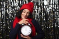 Woman with big alarm clock counting to midnight daydreaming Royalty Free Stock Photo