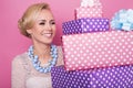 Woman with big beautiful smile holding colorful gift boxes. Soft colors. Christmas, birthday, Valentine day, presents Royalty Free Stock Photo