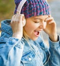 Woman with big headphone. Girl listens to music in headphones. Smiling girl relaxing, music a smartphone and headphones Royalty Free Stock Photo