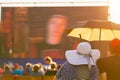 Woman in big white hat at the open air film festival