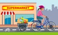 Woman on bike with groceries