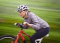Woman, bike and nature with ride, speed and fitness for health and wellness or workout. Athlete, cycling and exercise Royalty Free Stock Photo