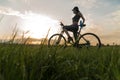 Woman bike sunset. exercise at sunset