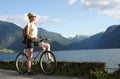 woman on a bike trip - mountains over the lake