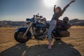 Woman biker sitting on her motorcycle