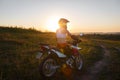 Woman biker in sunset, female motorcycle. Royalty Free Stock Photo