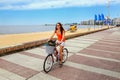 Woman biking on the boulevard along Pocitos beach in Montevideo, Uruguay. Royalty Free Stock Photo