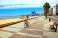 Woman biking on the boulevard along Pocitos beach in Montevideo, Uruguay. Royalty Free Stock Photo