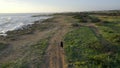 Woman Biking at the Seaside, Aerial at Sunset Royalty Free Stock Photo